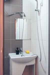 a bathroom with a white sink and a shower at BohoBox Studios in Plovdiv
