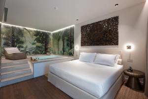 a bedroom with a bed and a bath tub at Savoy Beach Hotel & Thermal Spa in Bibione
