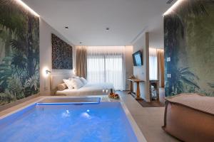 a hotel room with a large tub in the middle of a bedroom at Savoy Beach Hotel & Thermal Spa in Bibione