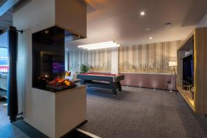 a living room with a pool table and a tv at Sandman Signature Glasgow Hotel in Glasgow