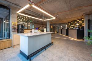 a large kitchen with a white counter in a room at Sandman Signature Glasgow Hotel in Glasgow