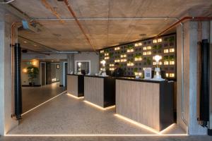 a restaurant with a bar with lights on the wall at Sandman Signature Glasgow Hotel in Glasgow