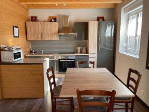 a kitchen with a table and chairs and a refrigerator at Marlibelle in Valff