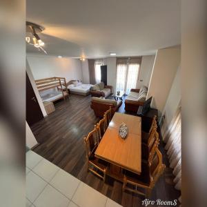 a living room with a wooden table and chairs at Ajro Rooms in Struga