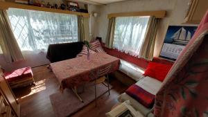 a room with a bed and a table and a couch at Domek holenderski u Grażynki in Kopalino