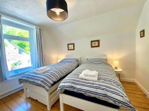 a bedroom with a bed with two pillows on it at 83 Gills Cliff Road in Ventnor