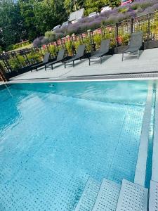 two pictures of a swimming pool with chairs next to it at Chata pod Lysou in Malenovice