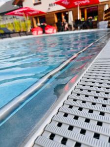 a large swimming pool with a swimming pooliterator at Chata pod Lysou in Malenovice