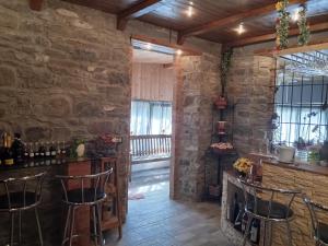 a bar in a room with a stone wall at B&B Ca' d'Andrea in San Martino