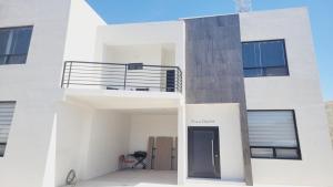a white apartment building with a black door at New Town Condo Casamar 4 near the beach in Puerto Peñasco