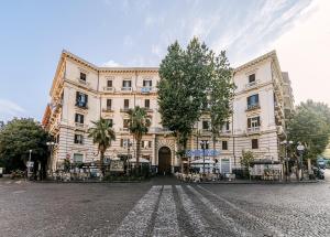 a large building on a cobblestone street at Gentile Suite & Spa Vomero in Naples