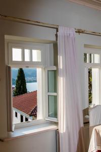 a room with two windows with a view of the water at The Dream in Kastoria