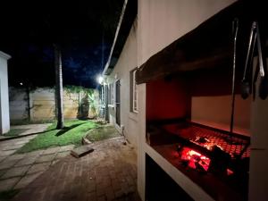 a room with a fireplace in a house at night at Casa Bravo - Pilgrims Palace in Pretoria