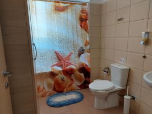 a bathroom with a shower with a stuffed animal in it at Pyla Palms Resort B1 - 1 in Larnaca