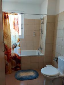 a bathroom with a tub and a toilet and a shower at Pyla Palms Resort B1 - 1 in Larnaca