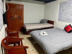 Green Sapa Homestay tesisinde bir odada yatak veya yataklar