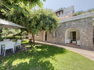 an external view of a garden with a table and chairs at Villa Cycas in Ischia Town
