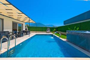 una piscina con patio y una casa en FETHİYE VİLLA İZCİ DELUX en Fethiye