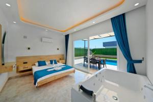 a bedroom with a bed and a bath tub at FETHİYE VİLLA İZCİ DELUX in Fethiye