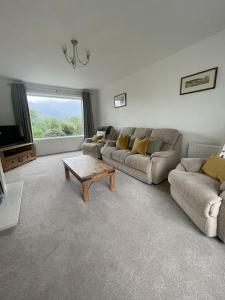 a living room with a couch and a coffee table at Roslin in Portinscale