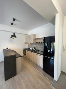 a kitchen with black appliances and a black refrigerator at Apartments IVI Gevgelija in Gevgelija