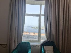 a window in a room with a view of the ocean at شقة كبيرة وفخمة large and luxury two bedroom in Ajman 