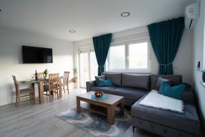 a living room with a couch and a table at Sunset View Apartments in Mostar