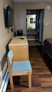 a room with a desk and a chair and a television at Bel Air Motor Lodge in Maple Shade +14 photos