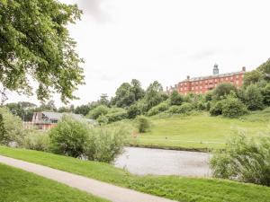 a view of a building from a park with a lake at 7 Monkmoor Road in Shrewsbury