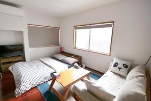 Posteľ alebo postele v izbe v ubytovaní Panda Stay Okayama