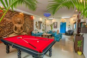 a living room with a pool table in front of a wall at Sukoon Farm Stay in New Delhi