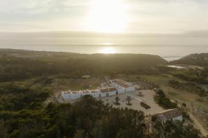 an aerial view of a building with the ocean in the background at Amaria in Aljezur