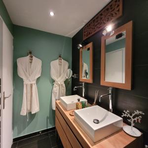 a bathroom with a sink and a mirror at LA VILLA MARIE in Richebourg