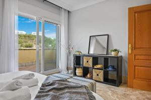 a bedroom with a bed and a mirror and a window at Incredible House in Santa Clara Golf w/ Parking in Marbella