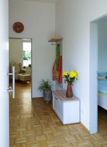 a living room with a vase of flowers on a table at Penthaus Kranichholz in Lüdinghausen