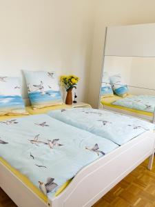 a bedroom with a bed with birds on it at Penthaus Kranichholz in Lüdinghausen