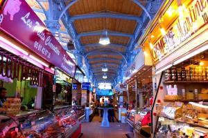 a market with many shops in a building at Coeur Toulouse St Cyprien T1 bis type Loft in Toulouse