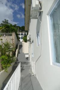 a stairway of a white building with a window at Healing in the City in Montego Bay