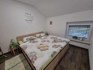 a bedroom with a bed with stuffed animals on it at Apartmaji Ribic in Ljubno