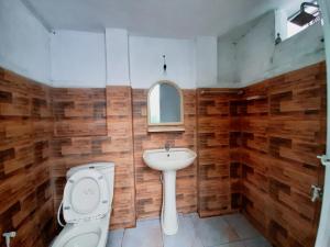 a bathroom with a toilet and a sink at Marette Holiday Bungalow in Moratuwa