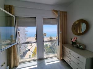 a room with a large window with a view of the ocean at Sea Village Real in Estepona