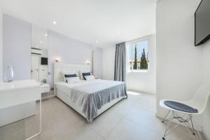 a white bedroom with a bed and a sink at Coração do Mar by OCvillas in Albufeira +51 photos