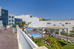 a balcony with a swimming pool on a building at Coração do Mar by OCvillas in Albufeira