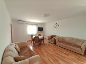 a living room with two couches and a table at Villa Marija in Cetinje