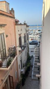 an alley with buildings and a car on the street at Palazzo Lamantea Boutique Rooms in Bisceglie