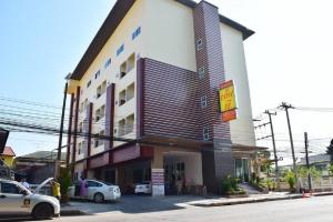 a building with cars parked in front of it at NP Residence in Nakhon Phanom