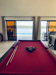 a pool table with a cue ball on top of it at Villa Assinie Bord de Lagune in Assinie