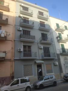 two cars parked in front of a building at Sweet Home Bari in Bari