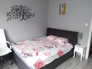 a bedroom with a bed with a tree on the wall at Czuj się jak u siebie in Zamość