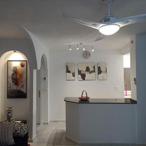 a room with a counter and a clock on the wall at Duquesa Beach in Torrevieja